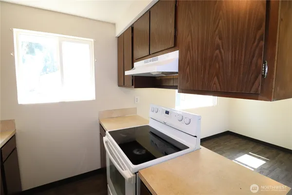 a kitchen with a stove and a microwave