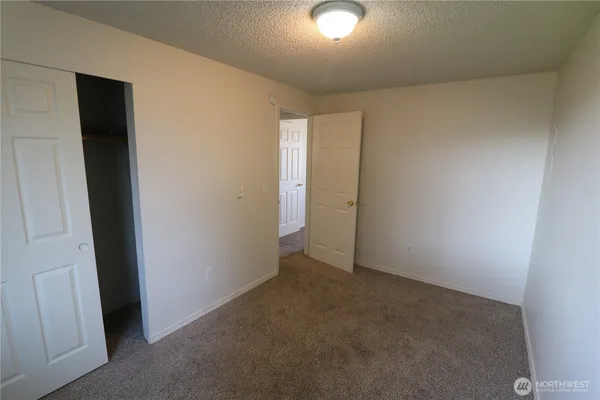 an empty room with closet area