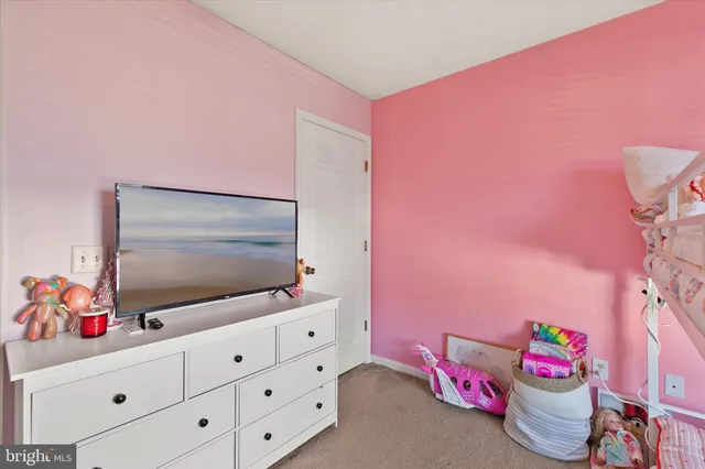 a living room with a flat screen tv and a dresser