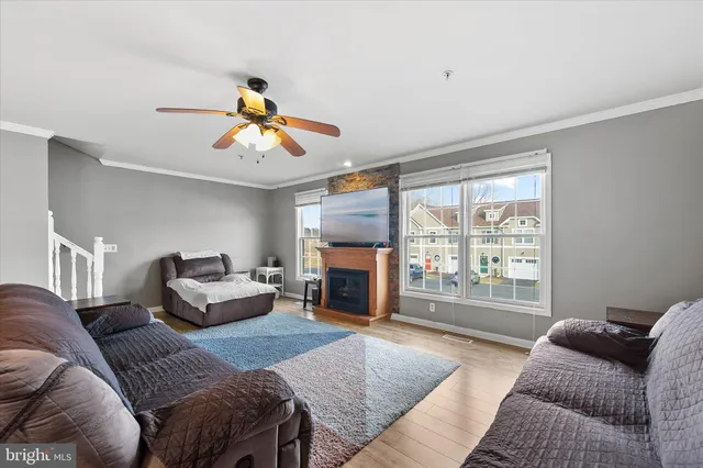 a living room with furniture large window and fireplace