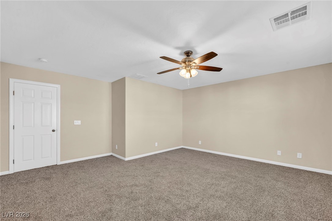 356 Aqua Springs Road Las Vegas, NV 89148 - Photo 26 of 39 Carpeted spare room featuring baseboards and ceiling fan