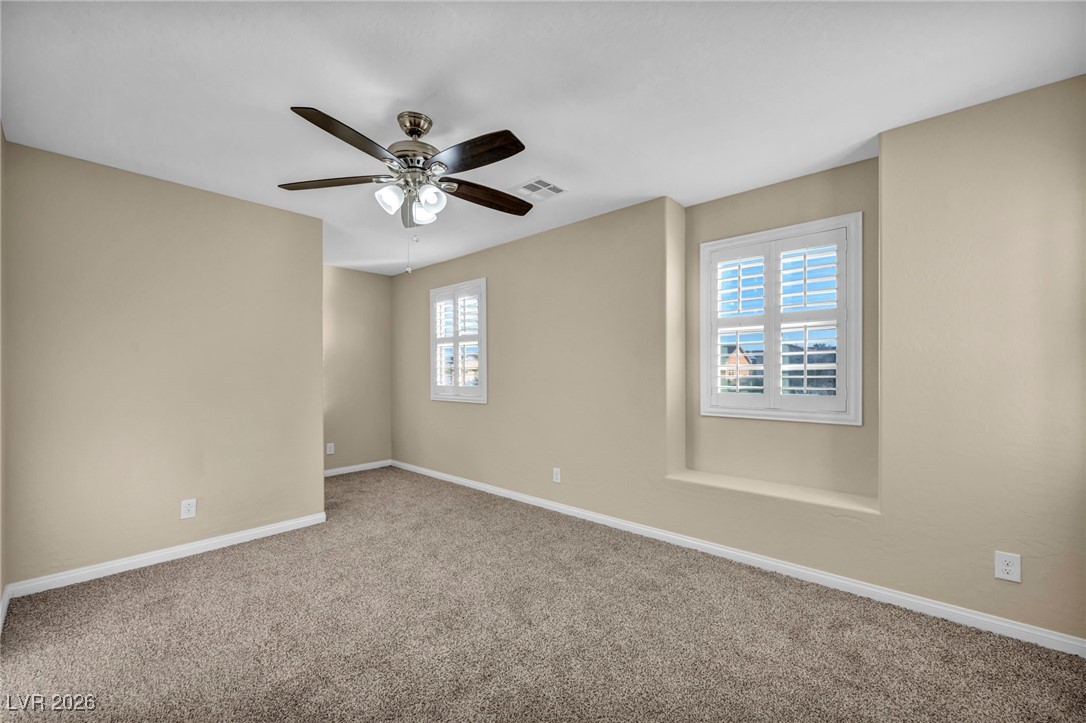 356 Aqua Springs Road Las Vegas, NV 89148 - Photo 27 of 39 Carpeted empty room featuring baseboards and ceiling fan