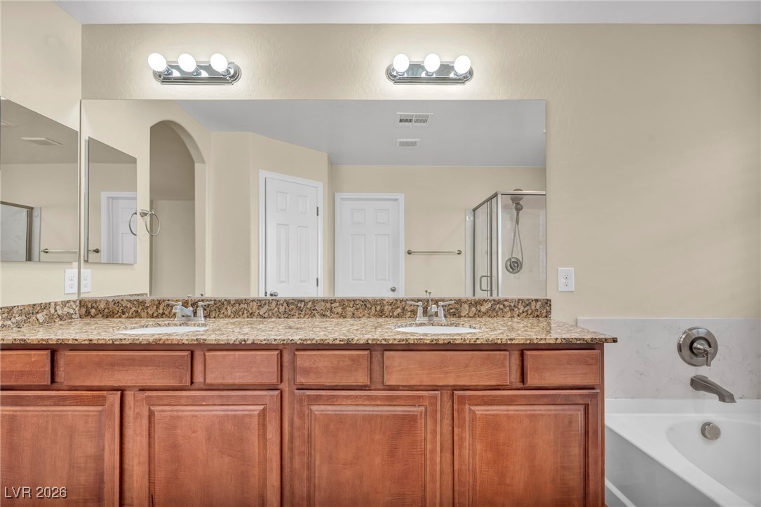 356 Aqua Springs Road Las Vegas, NV 89148 - Photo 30 of 39 Bathroom with a bath, double vanity, and a shower stall