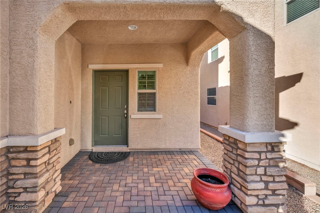 356 Aqua Springs Road Las Vegas, NV 89148 - Photo 3 of 39 Property entrance featuring stucco siding and a porch