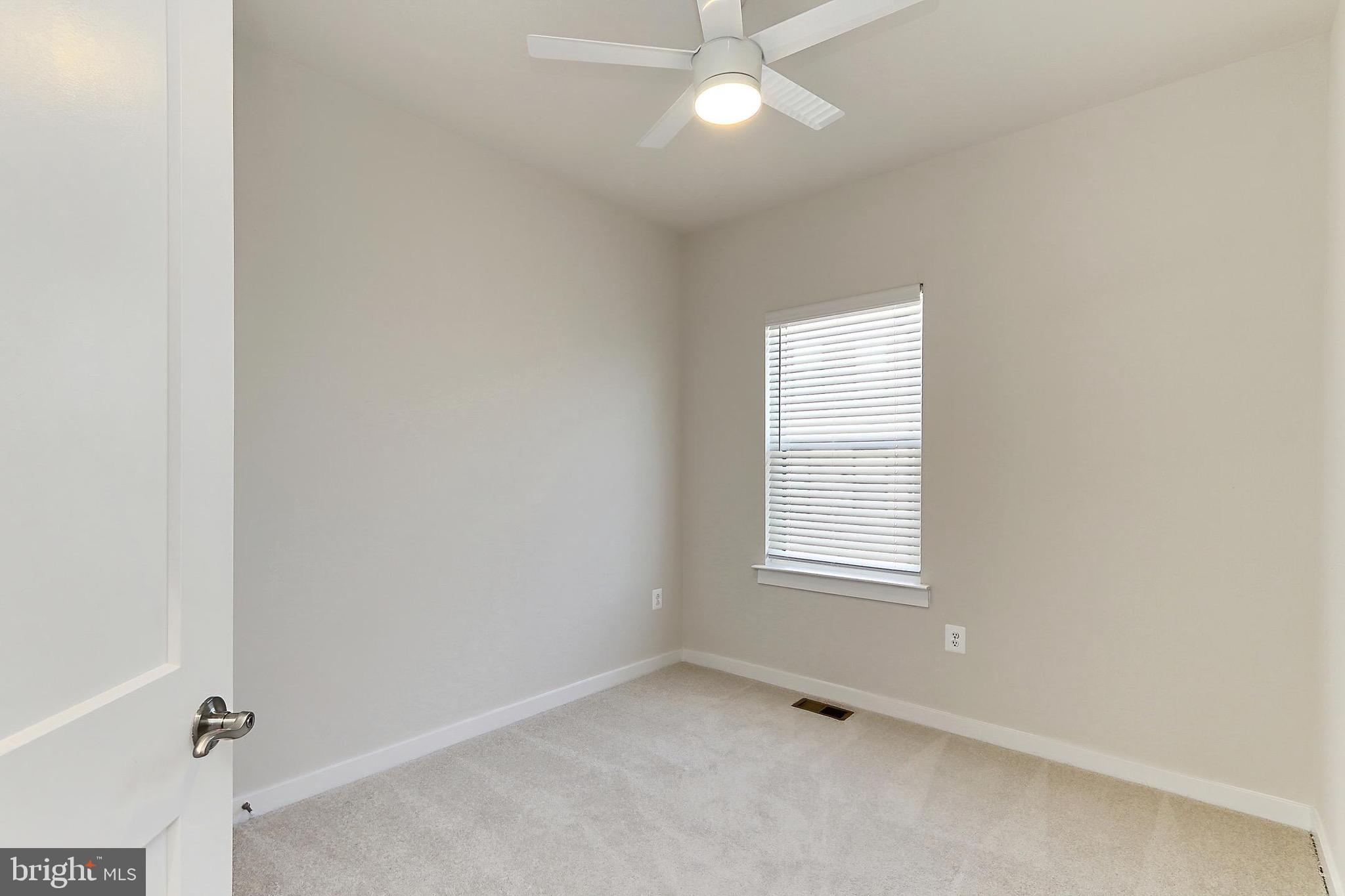 14176 Gypsum Loop Chantilly, VA 20151 - Photo 42 of 44 an empty room with a window and chandelier fan