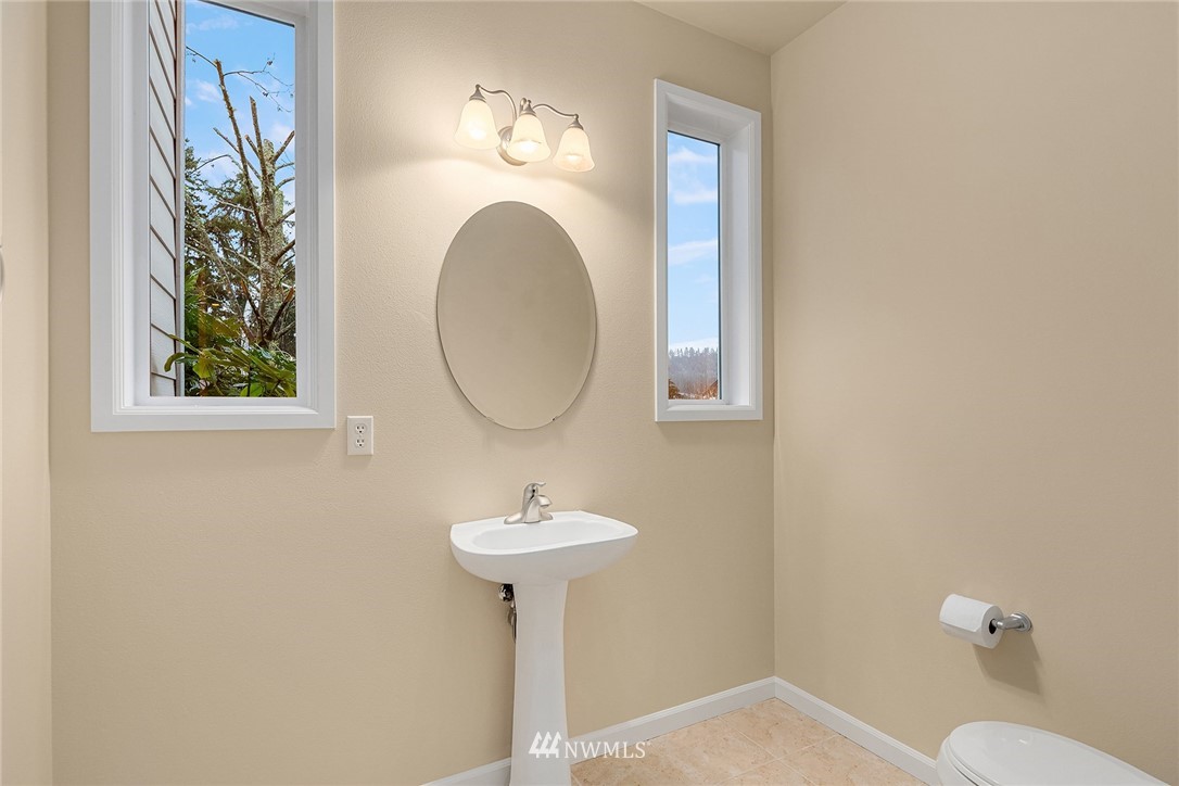 4209 Northeast 27th Place Renton, WA 98059 - Photo 19 of 35 a bathroom with a sink toilet and a mirror