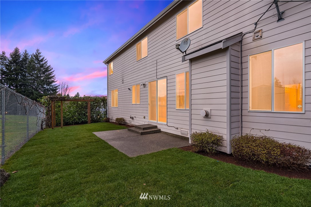 4209 Northeast 27th Place Renton, WA 98059 - Photo 3 of 35 a view of a backyard with plants and a large tree