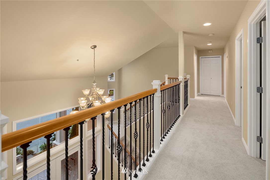 4209 Northeast 27th Place Renton, WA 98059 - Photo 21 of 35 a view of a hallway with wooden floor