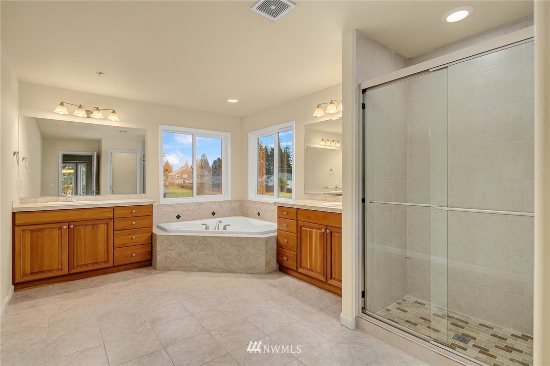 4209 Northeast 27th Place Renton, WA 98059 - Photo 24 of 35 a large spacious bathroom with a granite countertop tub sink shower and mirror