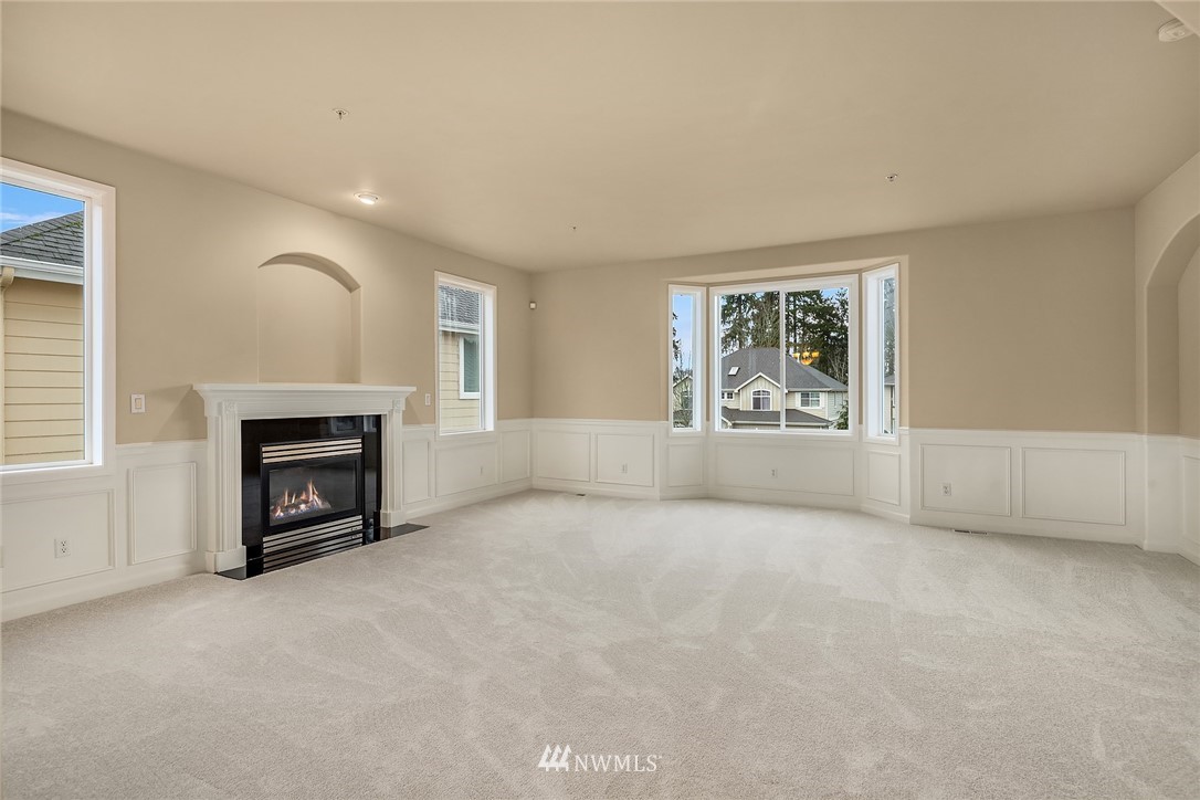 4209 Northeast 27th Place Renton, WA 98059 - Photo 9 of 35 an empty room with windows and fireplace