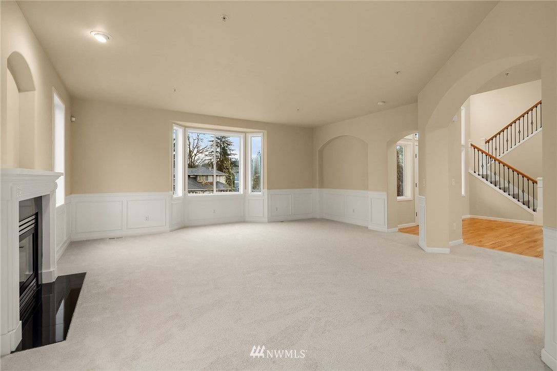 4209 Northeast 27th Place Renton, WA 98059 - Photo 10 of 35 a view of an empty room with a fireplace and a window
