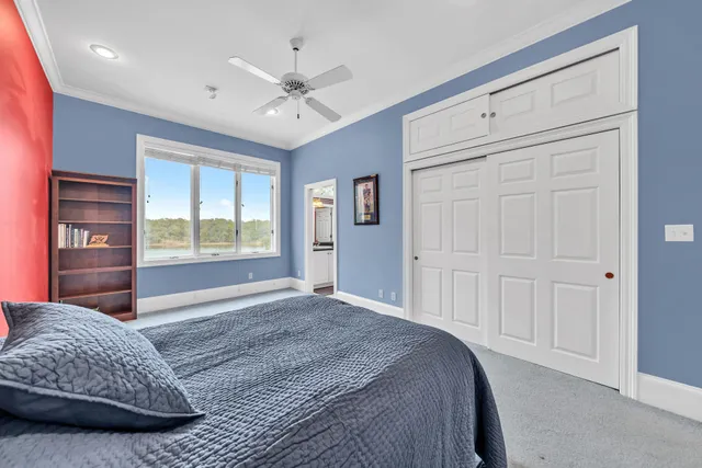 an aerial view of ocean and residential houses with outdoor space