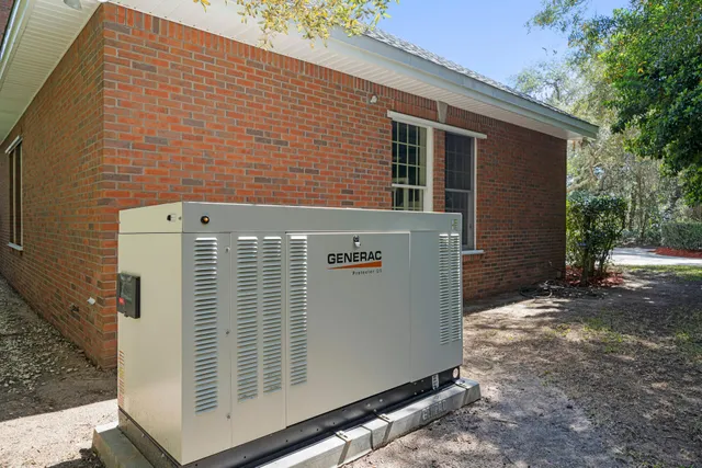 a dining room with furniture floor to ceiling window and potted plants