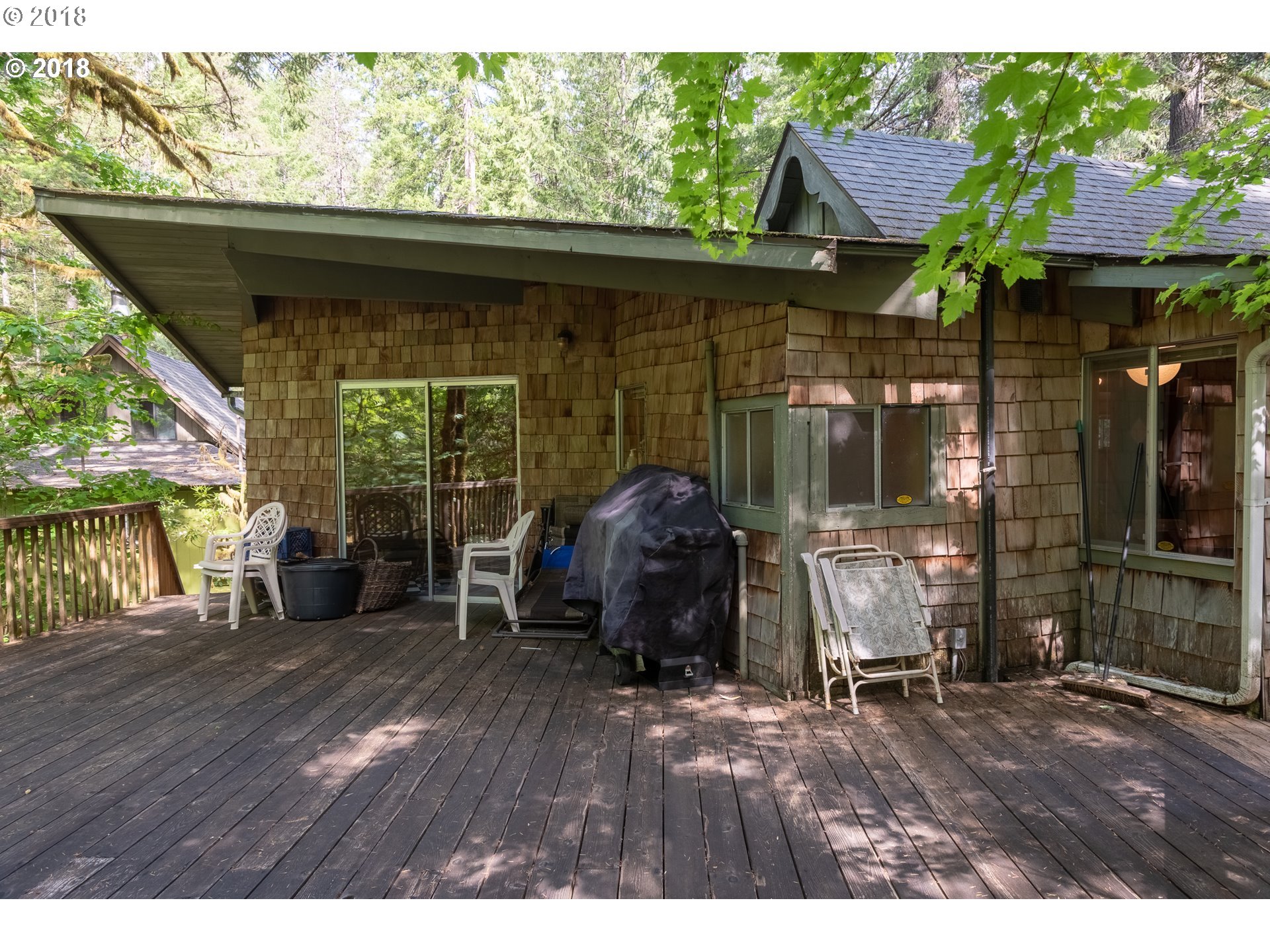 74856 Road 26, Unit 44 Rhododendron, OR 97049 - Photo 26 of 28 a backyard of a house with barbeque oven table and chairs