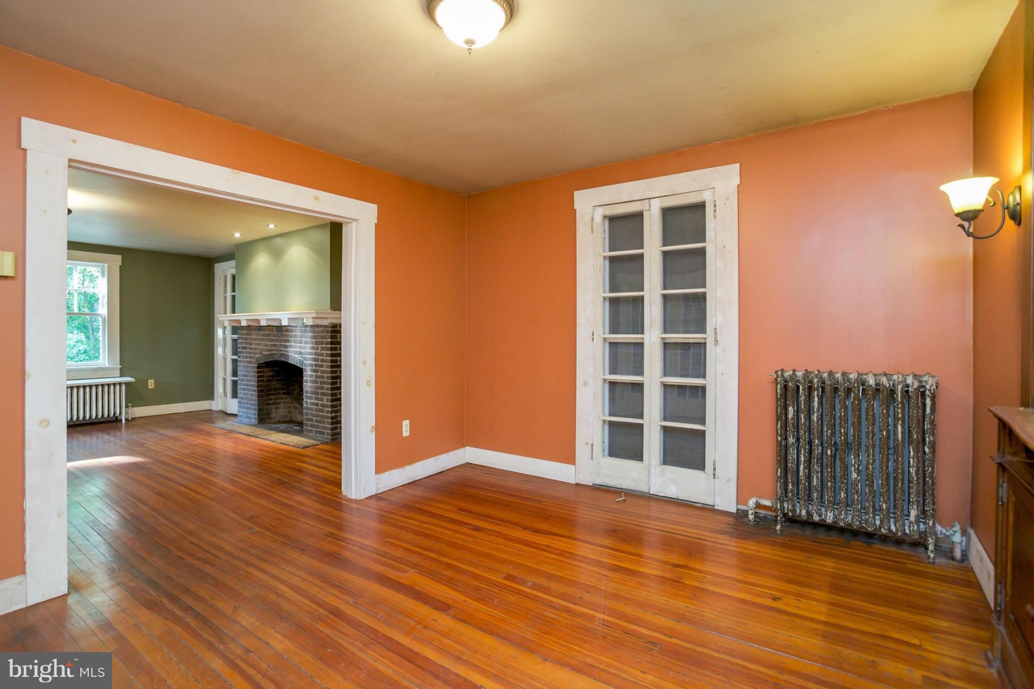 1730 Carrs Mill Road Fallston, MD 21047 - Photo 10 of 29 an empty room with wooden floor fireplace and windows
