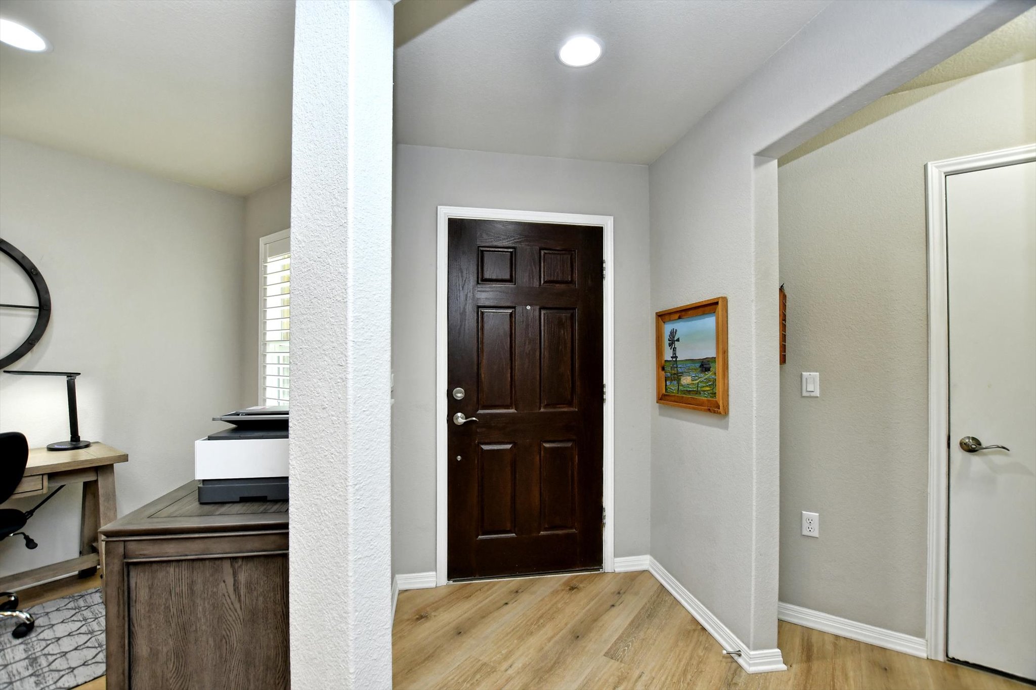 231 Hobby Street Georgetown, TX 78633 - Photo 4 of 29 A dark paneled door welcomes all, set against light flooring and a subtle wall tone.