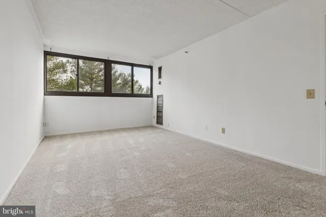 a view of an empty room with a window