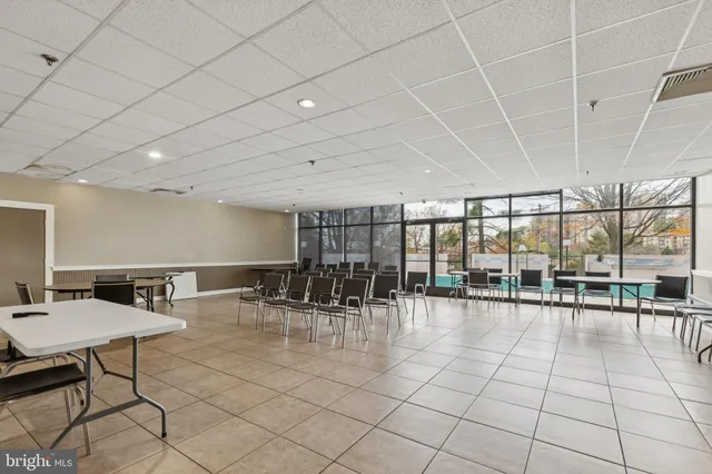 a lobby with furniture and floor to ceiling window