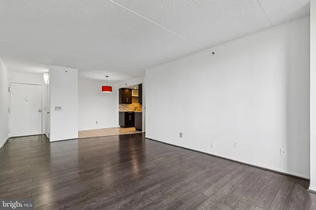 a view of an empty room with wooden floor