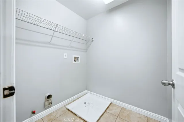 a view of backyard with plants and wooden fence