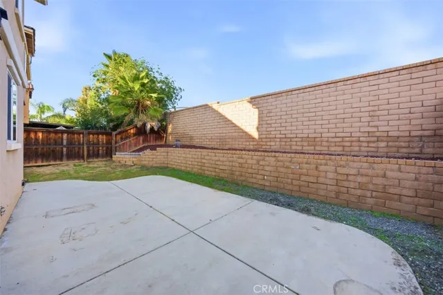 a view of a house with a yard and wooden fence