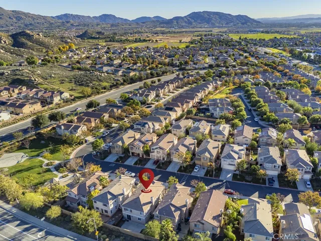 an aerial view of residential houses with outdoor space