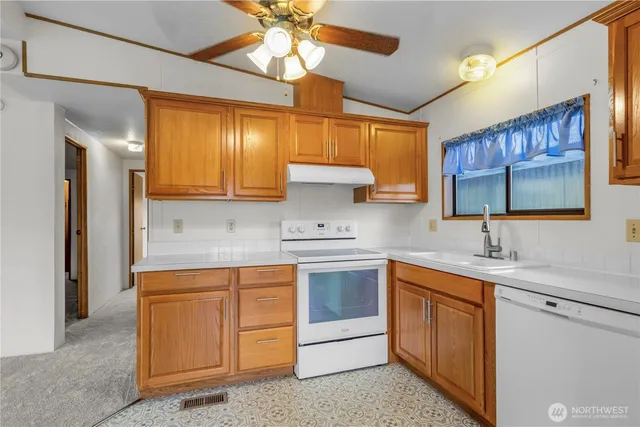 a kitchen with a sink cabinets and window