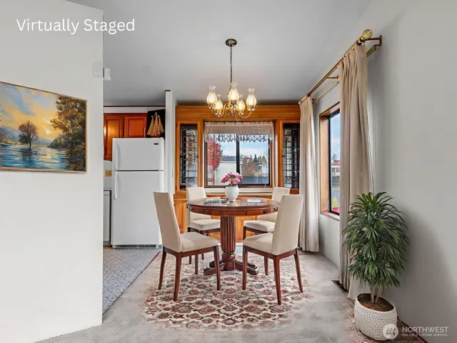 a dining room with furniture potted plants and wooden floor