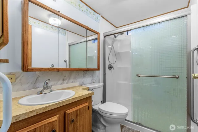 a bathroom with a sink toilet and shower