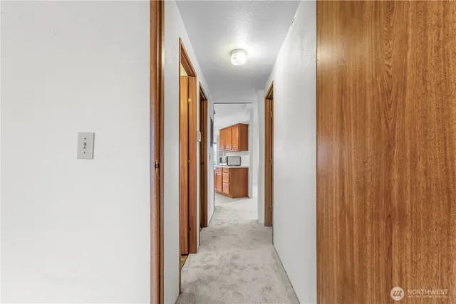 a view of a hallway with wooden shelves