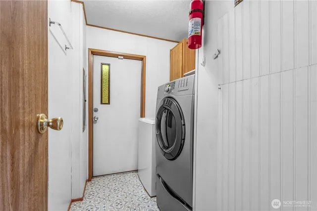 a view of a hallway with washer and dryer
