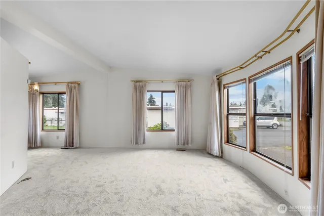 a view of an empty room with glass door and balcony