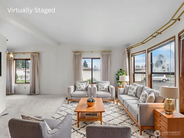 a living room with furniture large window and couch