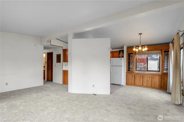 a view of a kitchen with a refrigerator a microwave and a sink