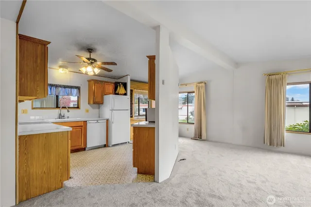 a view of kitchen with cabinets and flat screen tv