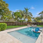 a view of a backyard with sitting area