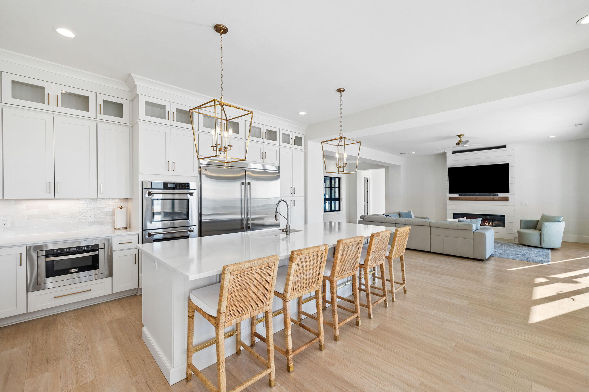 253 Driftwood Point Road Santa Rosa Beach, FL 32459 - Photo 21 of 109 a kitchen with stainless steel appliances kitchen island granite countertop a stove a refrigerator a oven a sink with a dining table and chairs with wooden floor