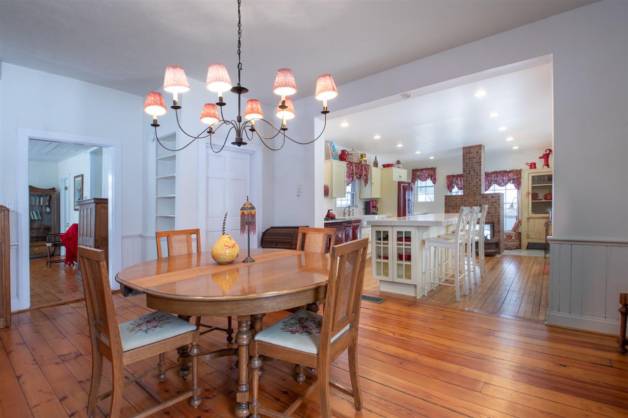 524 Hunter Road Caledonia, IL 61011 - Photo 11 of 32 a dining room filled with furniture a chandelier and wooden floor