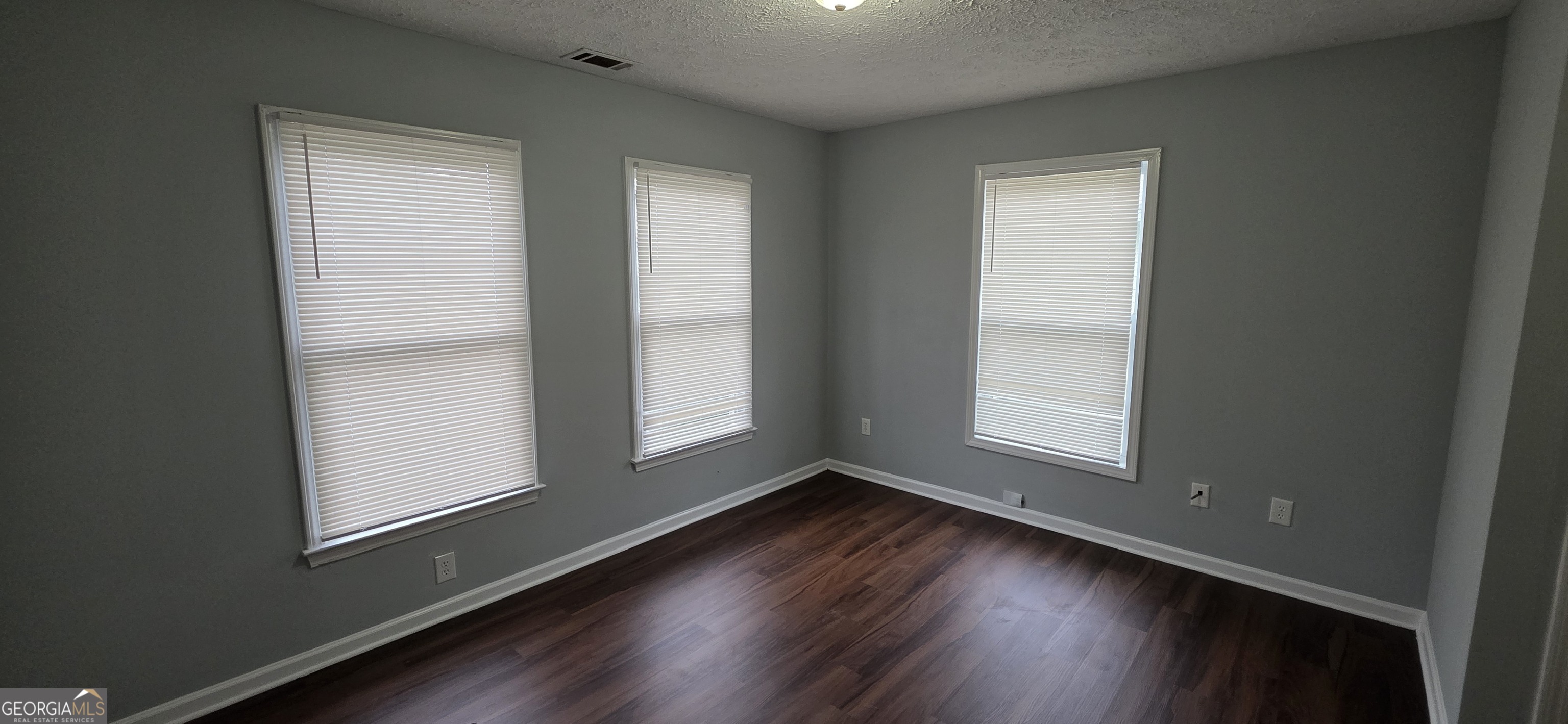 688 Smith Street Southwest Atlanta, GA 30310 - Photo 3 of 15 an empty room with wooden floor and windows