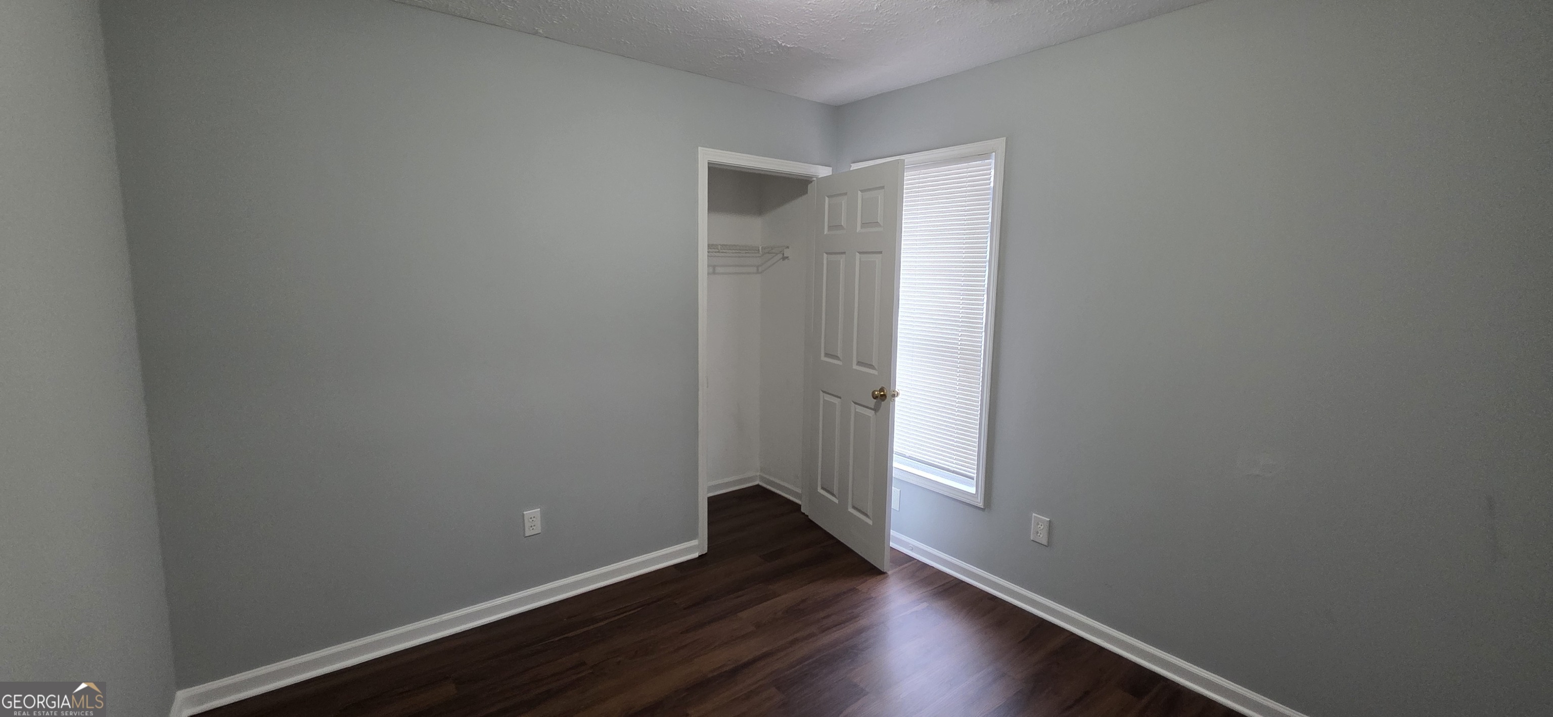 688 Smith Street Southwest Atlanta, GA 30310 - Photo 5 of 15 a view of an empty room with wooden floor and a window