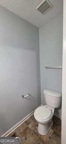 a white toilet sitting next to a shower