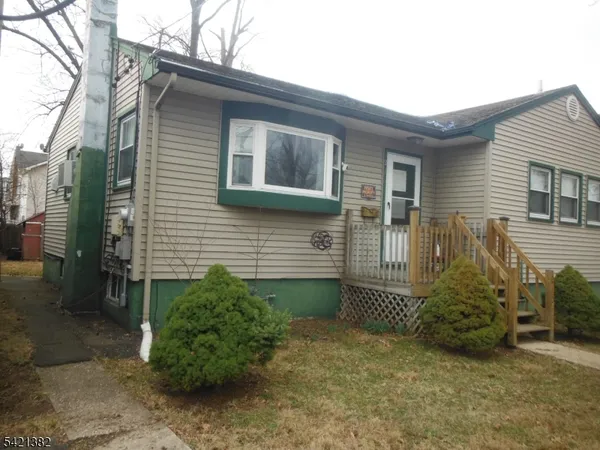a view of a house with a small yard and plants