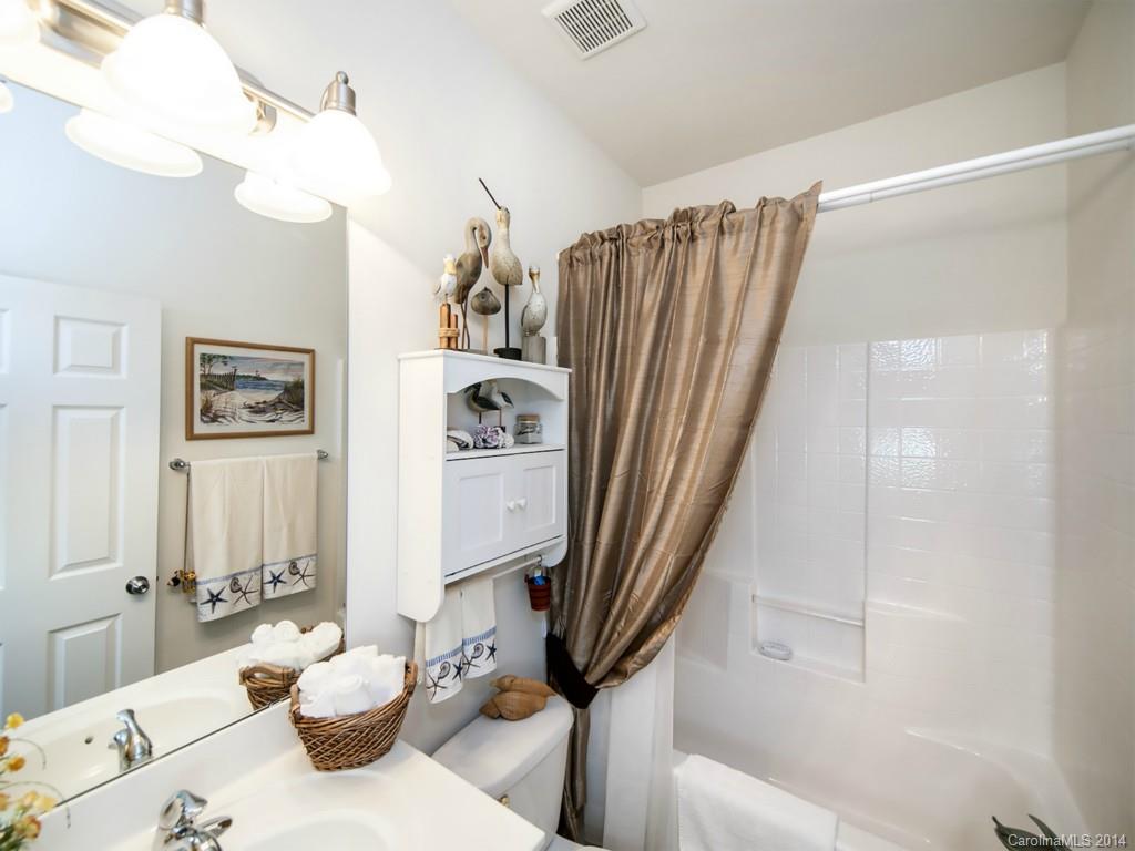826 Solandra Way Tega Cay, SC 29708 - Photo 16 of 21 a bathroom with a sink a toilet and a mirror