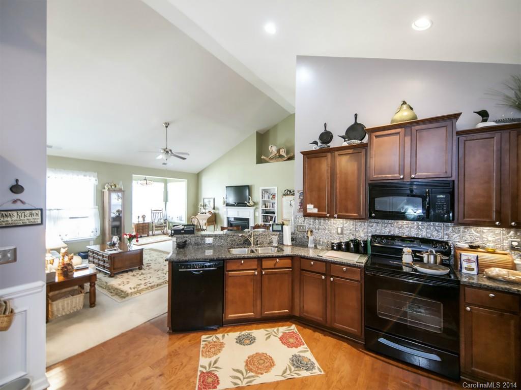 826 Solandra Way Tega Cay, SC 29708 - Photo 8 of 21 a kitchen with a stove a sink and a refrigerator