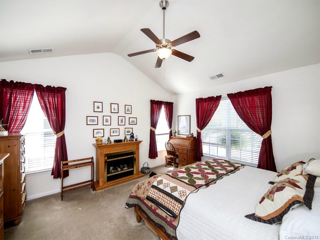 826 Solandra Way Tega Cay, SC 29708 - Photo 9 of 21 a bedroom with a bed and a fireplace
