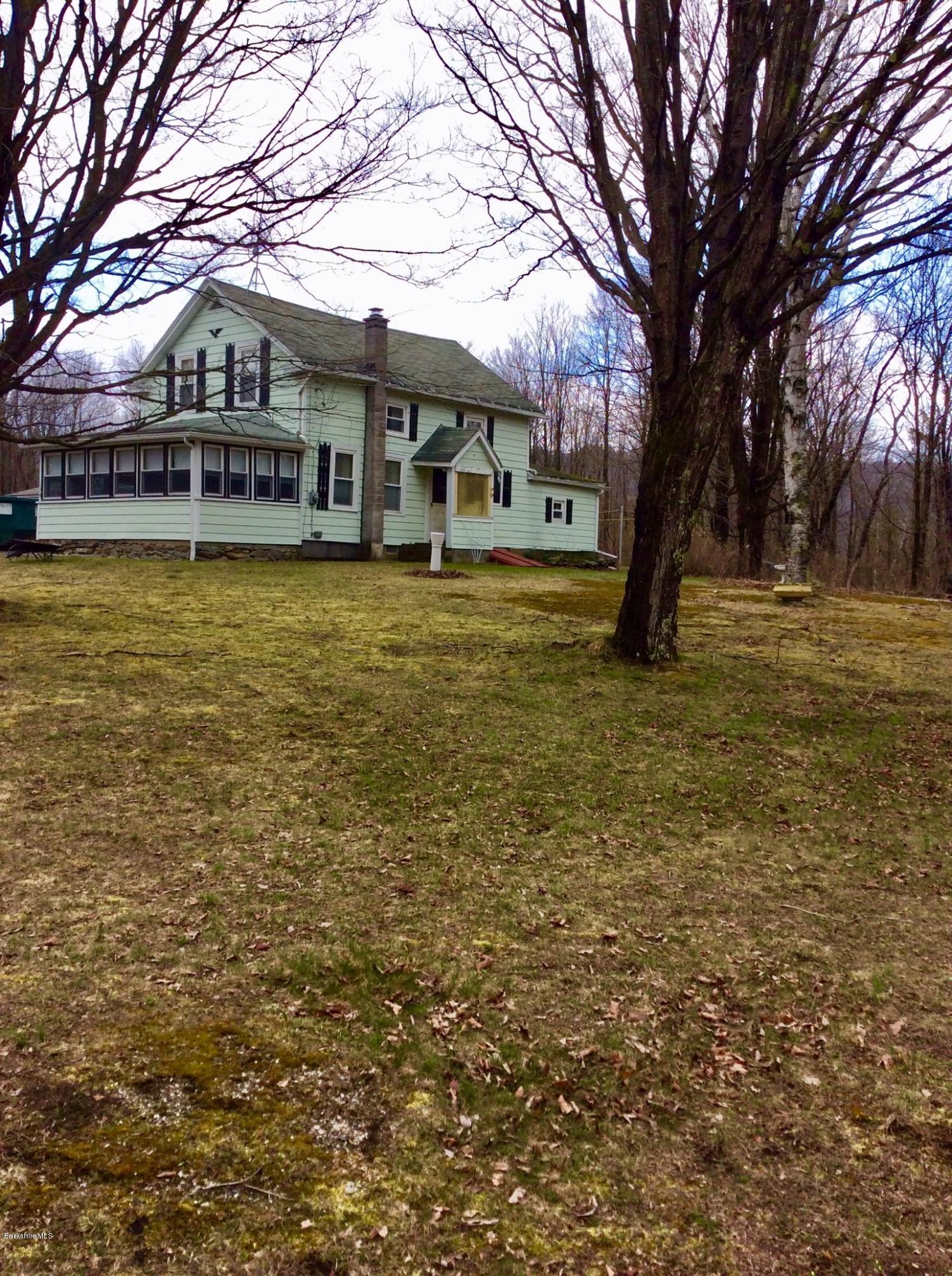 134 Bancroft Road Becket, MA 01223 - Photo 2 of 17 a house with a trees in front of it