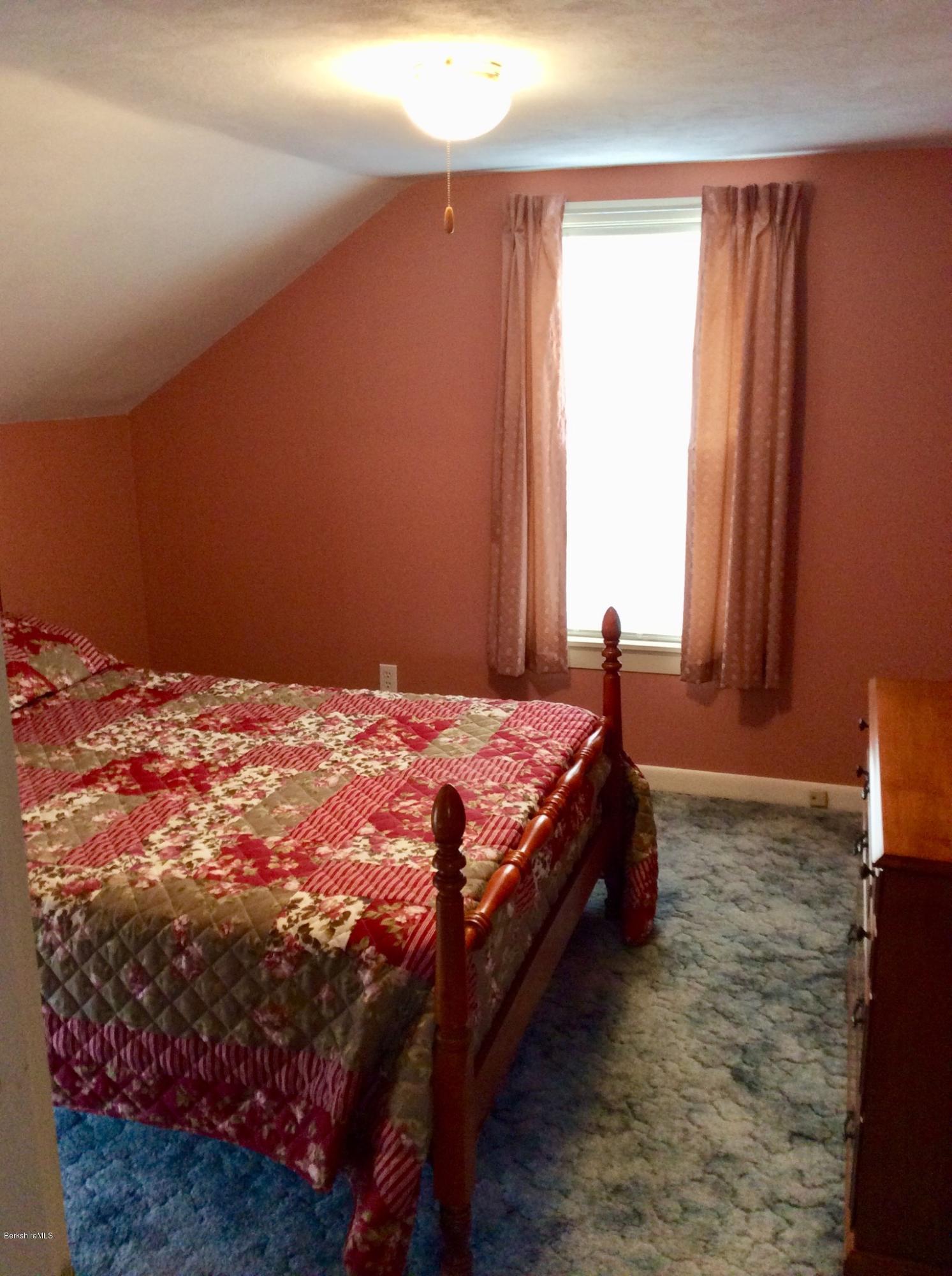 134 Bancroft Road Becket, MA 01223 - Photo 14 of 17 a bedroom with a bed and window