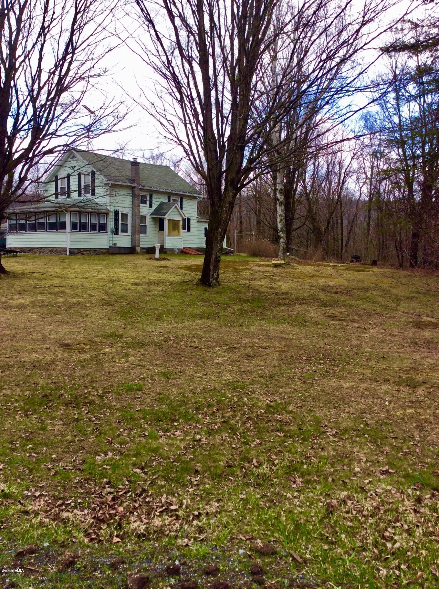 134 Bancroft Road Becket, MA 01223 - Photo 3 of 17 a front view of house with yard and trees