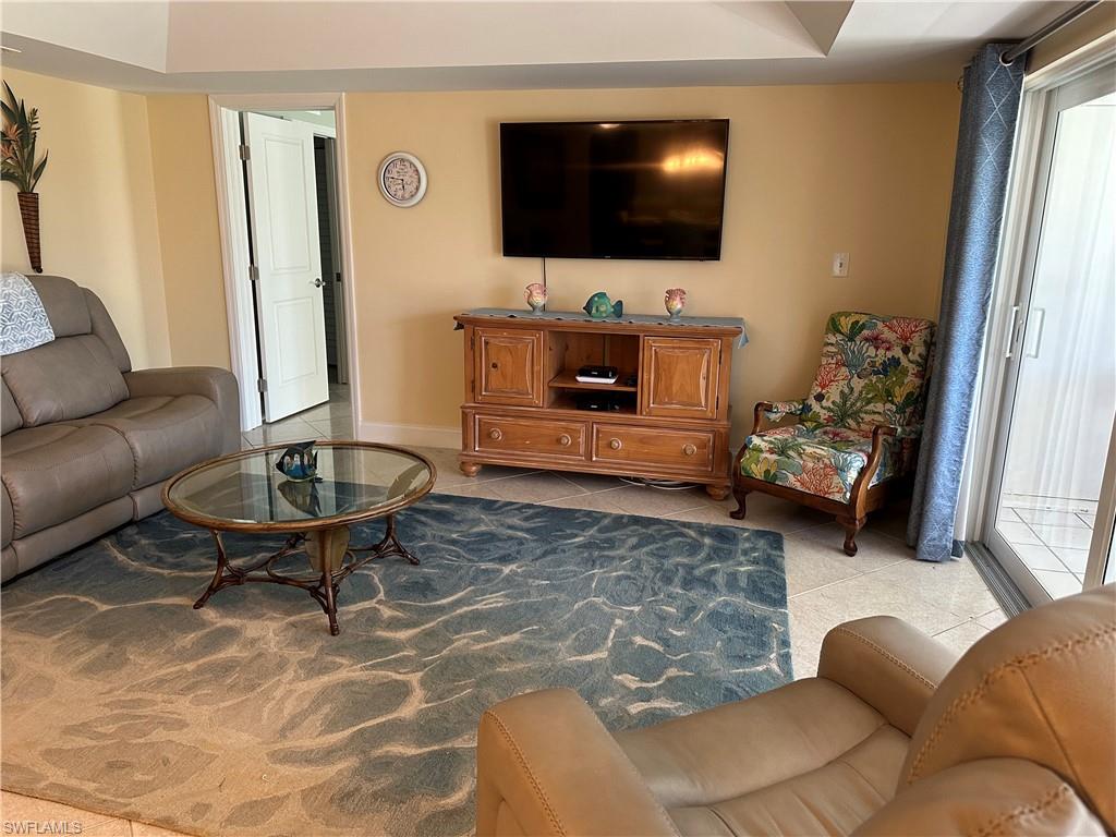 263 Candycane Lane, Unit 5 Naples, FL 34112 - Photo 20 of 49 a living room with furniture and a flat screen tv