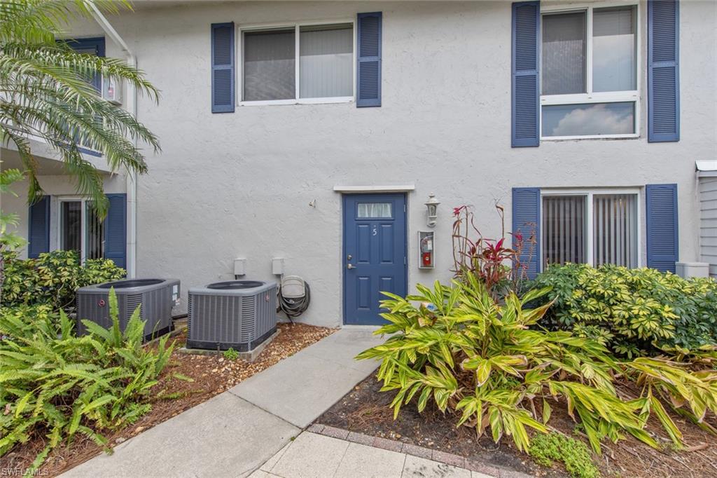 263 Candycane Lane, Unit 5 Naples, FL 34112 - Photo 2 of 49 a view of a house with potted plants